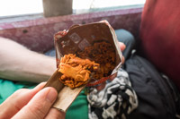 a very tasty snack on the bus. Cardboard serves as a spoon. 