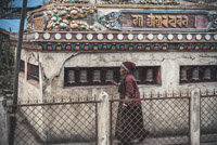 a local woman spinning the prayer wheels - also always clockwise
